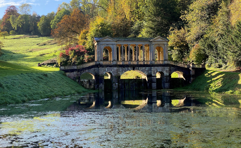 Palladian bridge in Prior Park surrounded by autumnal trees